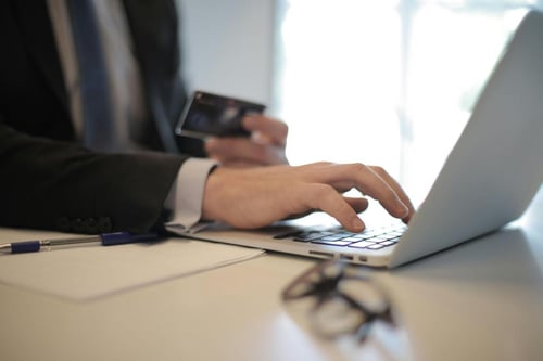 A person paying for an online purchase using a card