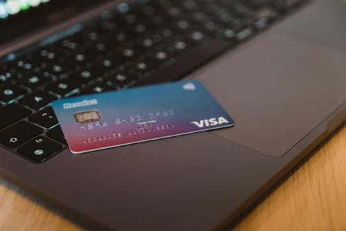 A visa debit card on a laptop
